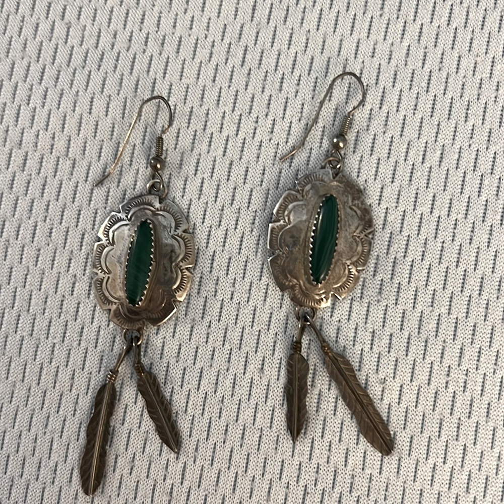 Sterling silver earrings. Green stone and beautiful detail silver feathers.